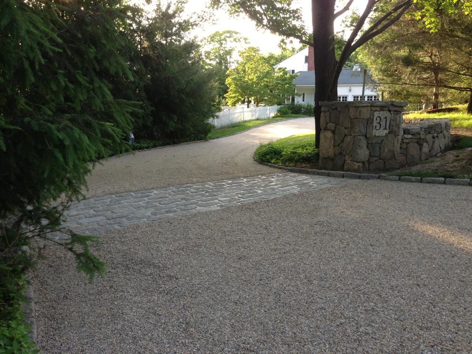 Inspiration for a large traditional shade front yard gravel driveway in New York.