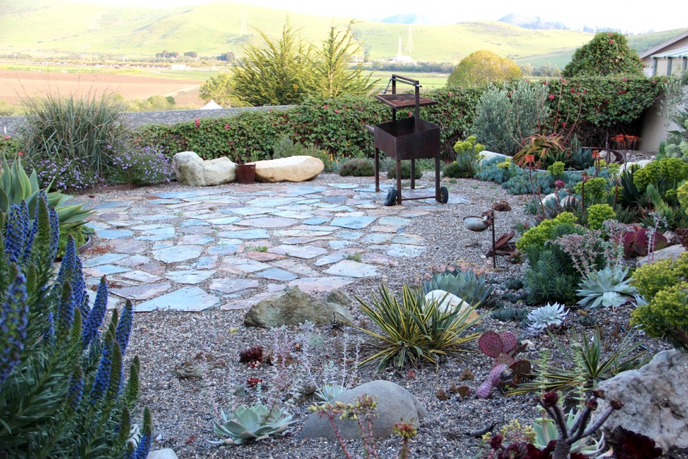 Inspiration for a mediterranean courtyard xeriscape garden in San Luis Obispo with a fire feature and natural stone paving.