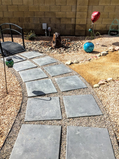 Design ideas for a small world-inspired back xeriscape full sun garden for spring in Phoenix with a garden path and gravel.