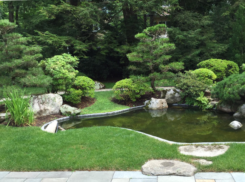 Inspiration for a large asian full sun backyard stone water fountain landscape in Boston for summer.