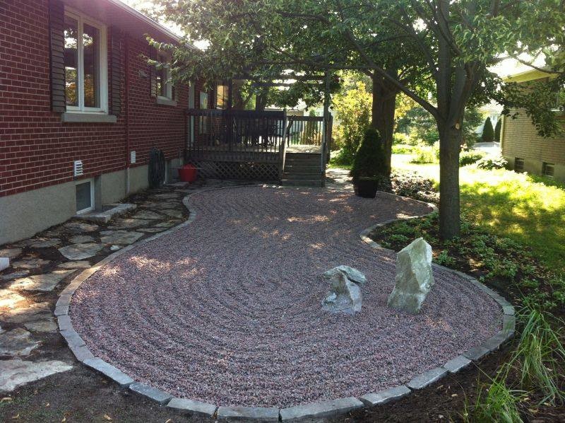 This is an example of a large asian shade backyard stone landscaping in Ottawa.