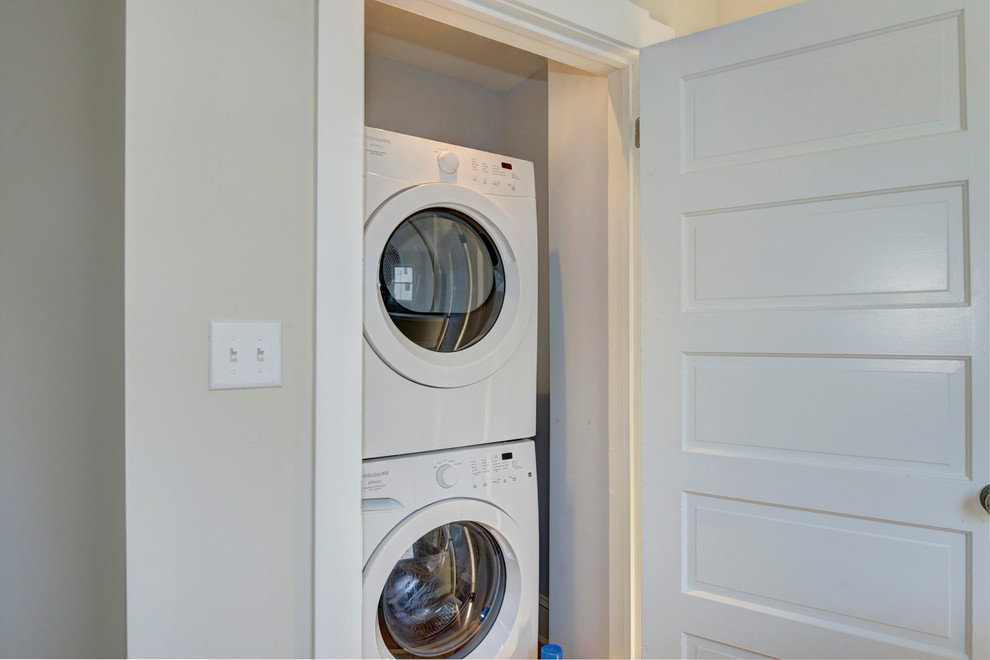 Inspiration for a timeless ceramic tile laundry closet remodel in DC Metro with a stacked washer/dryer