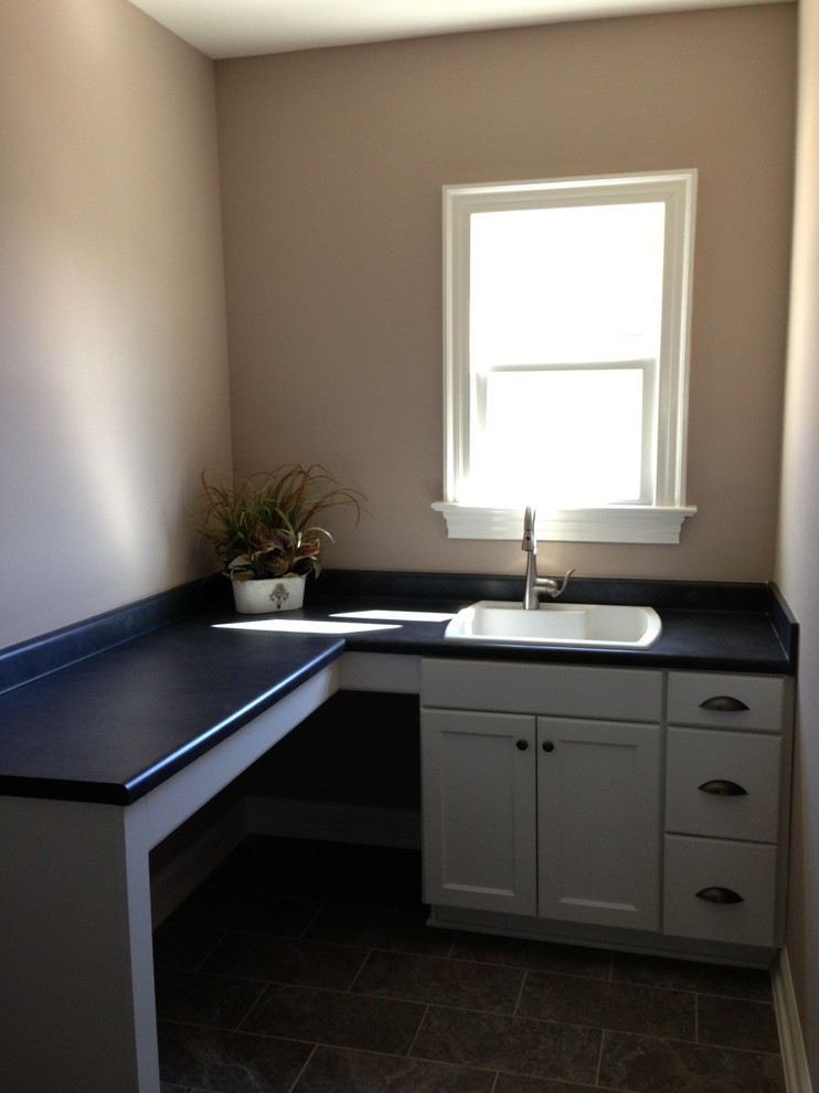 Elegant laundry room photo in Raleigh