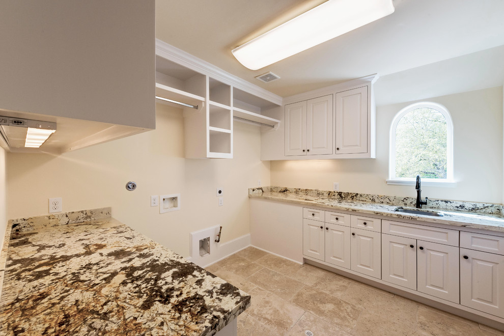 Dedicated laundry room - large mediterranean galley limestone floor dedicated laundry room idea in Houston with an undermount sink, granite countertops, a side-by-side washer/dryer and beige walls