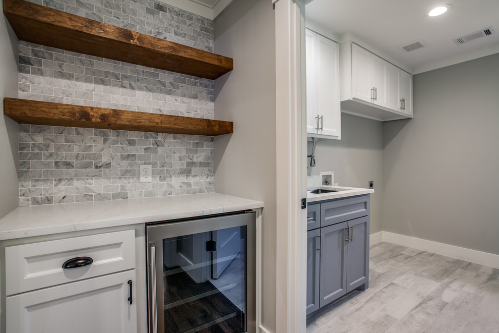 Design ideas for a traditional galley separated utility room in Dallas with a submerged sink, shaker cabinets, white cabinets, engineered stone countertops, grey walls, porcelain flooring, a side by side washer and dryer, grey floors and white worktops.