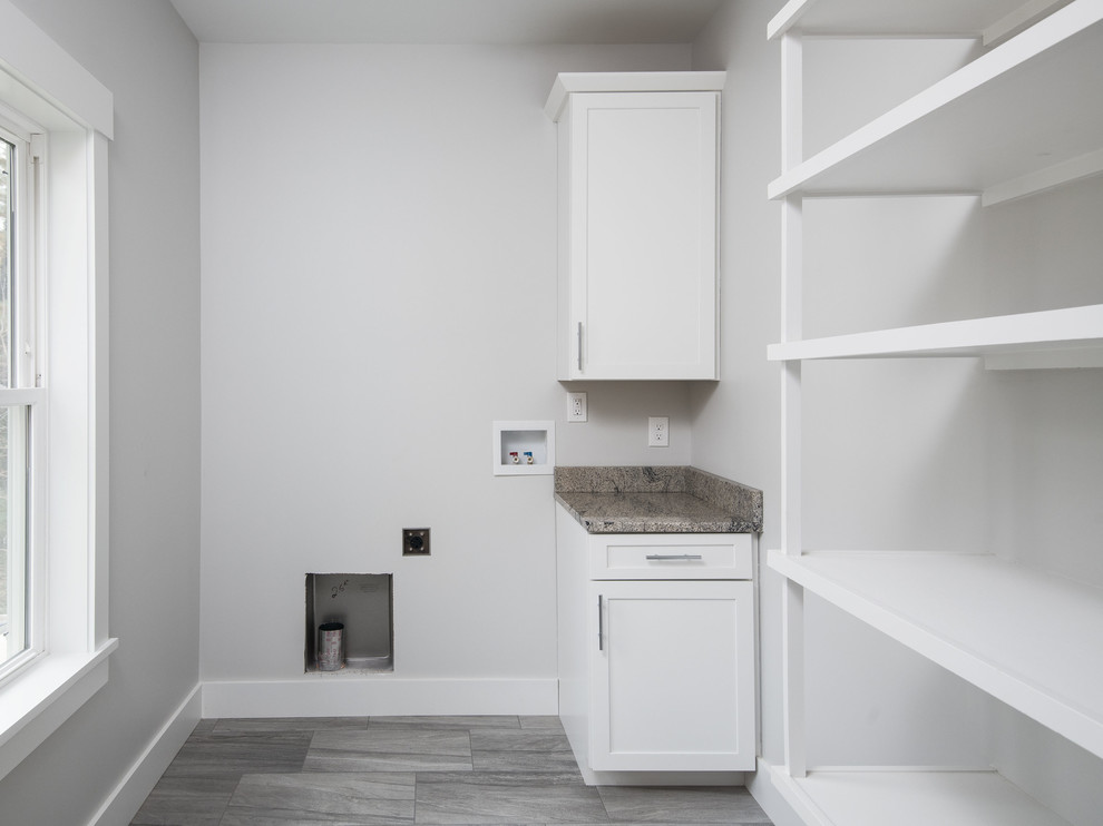 Mid-sized transitional single-wall porcelain tile and gray floor utility room photo in Other with shaker cabinets, white cabinets, granite countertops, gray walls, a side-by-side washer/dryer and gray countertops