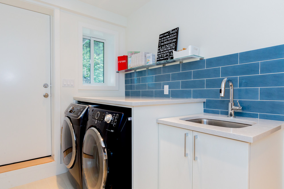 Inspiration for a mid-sized modern galley ceramic tile dedicated laundry room remodel in Vancouver with an undermount sink, flat-panel cabinets, white cabinets, quartz countertops, gray walls and a side-by-side washer/dryer