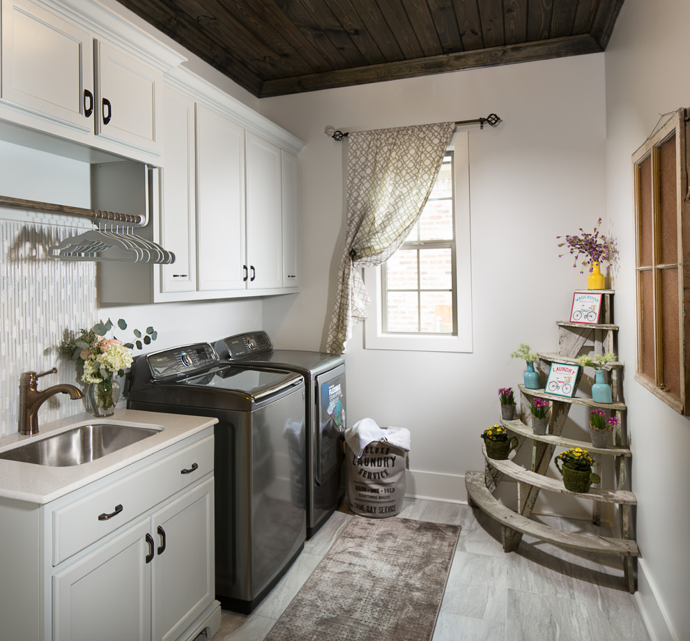 Dedicated laundry room - mid-sized country single-wall ceramic tile dedicated laundry room idea in New Orleans with an undermount sink, a side-by-side washer/dryer and recessed-panel cabinets