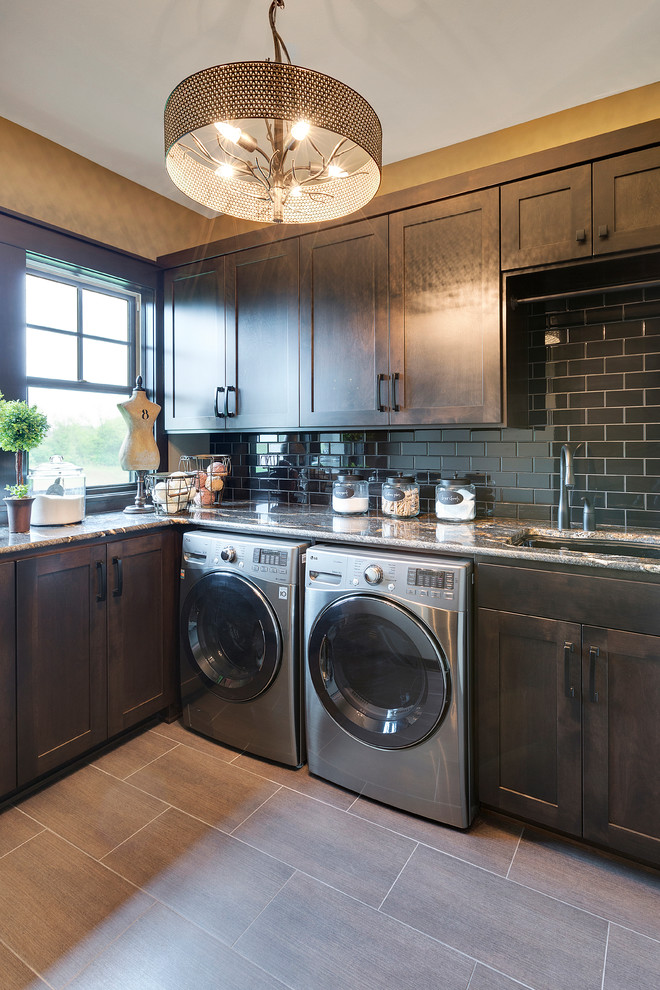 Dedicated laundry room - large traditional l-shaped porcelain tile dedicated laundry room idea in Minneapolis with an undermount sink, shaker cabinets, dark wood cabinets, granite countertops, beige walls and a side-by-side washer/dryer