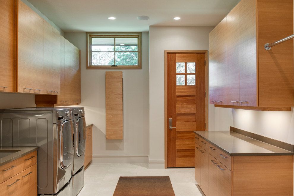 Large contemporary galley separated utility room in Minneapolis with a submerged sink, flat-panel cabinets, medium wood cabinets, quartz worktops, white walls, porcelain flooring and a side by side washer and dryer.