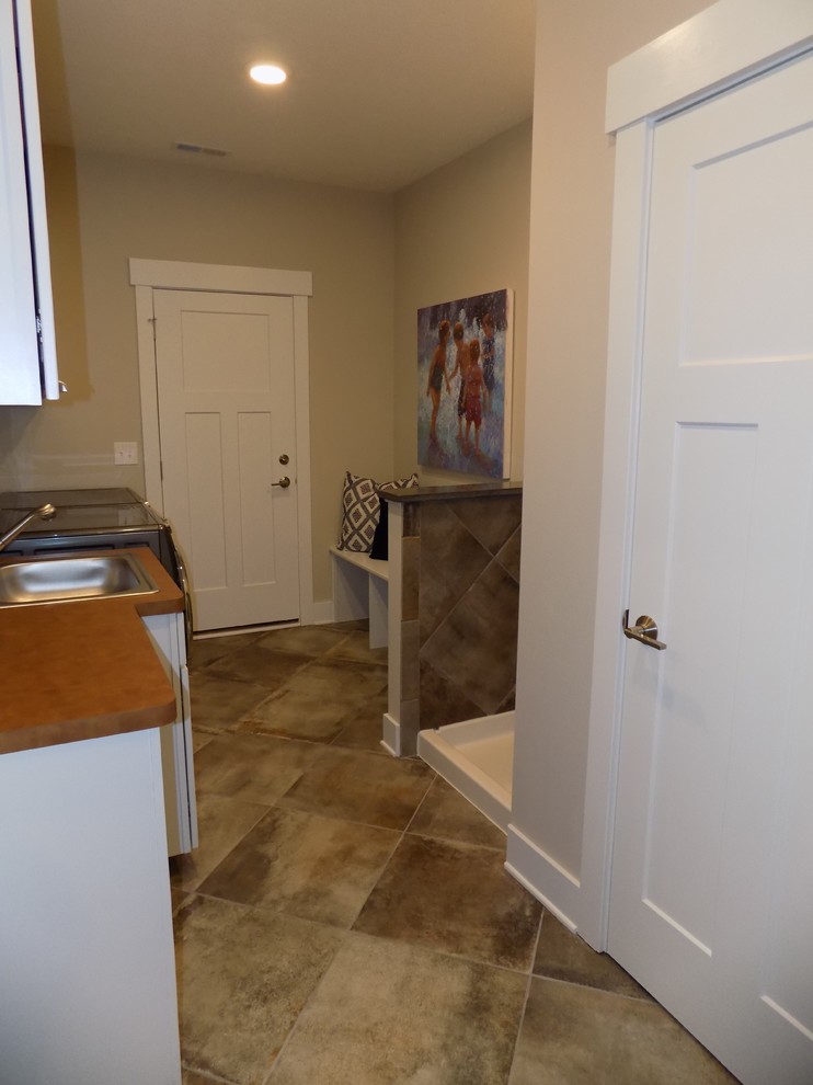 Medium sized traditional galley separated utility room in Columbus with a built-in sink, recessed-panel cabinets, white cabinets, laminate countertops, beige walls, porcelain flooring, a side by side washer and dryer and multi-coloured floors.