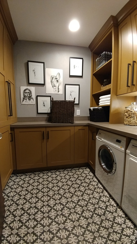 Inspiration för små klassiska u-formade tvättstugor enbart för tvätt, med släta luckor, gula skåp, laminatbänkskiva, grå väggar, klinkergolv i keramik, en tvättmaskin och torktumlare bredvid varandra och grått golv