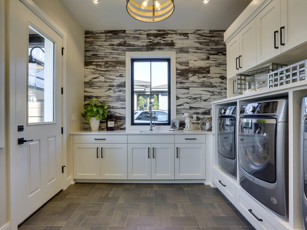 Photo of a large farmhouse l-shaped separated utility room in Portland with a submerged sink, shaker cabinets, white cabinets, engineered stone countertops, multi-coloured walls, ceramic flooring, a side by side washer and dryer and brown floors.