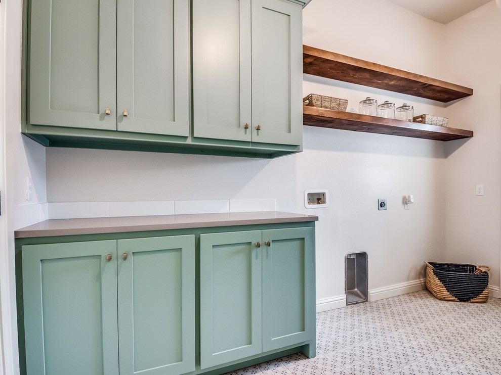 Design ideas for a large farmhouse galley separated utility room in Oklahoma City with shaker cabinets, blue cabinets, engineered stone countertops, beige walls, ceramic flooring, a side by side washer and dryer, multi-coloured floors and grey worktops.