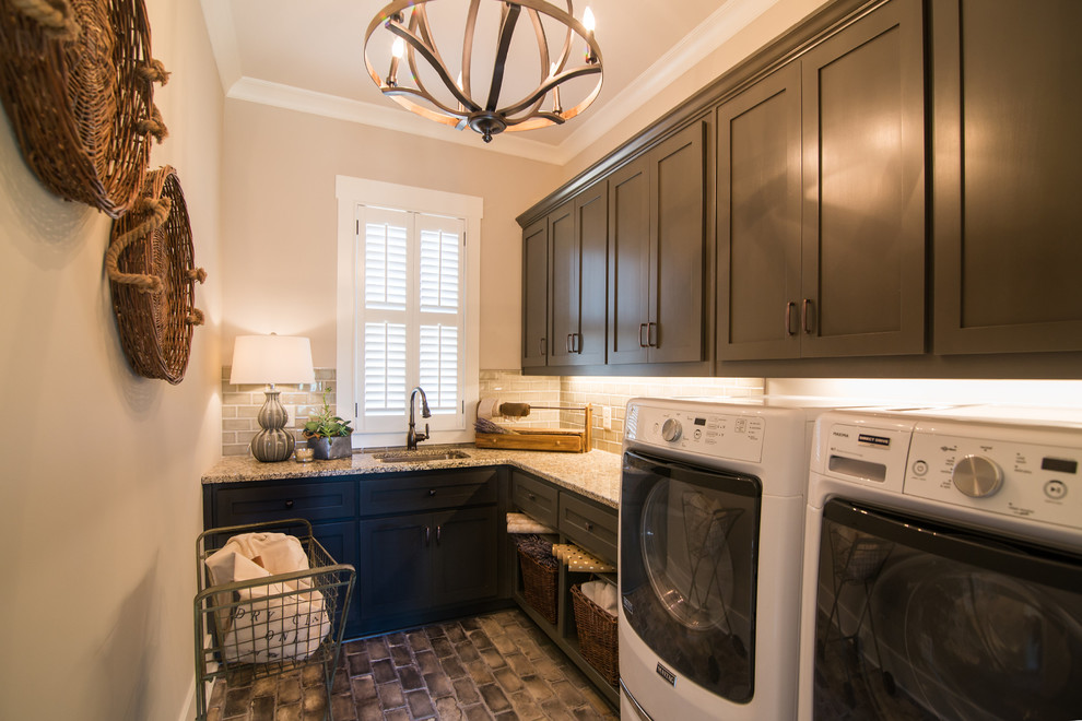 Example of a mid-sized transitional l-shaped brick floor dedicated laundry room design in Atlanta with an undermount sink, shaker cabinets, gray cabinets, granite countertops, beige walls and a side-by-side washer/dryer