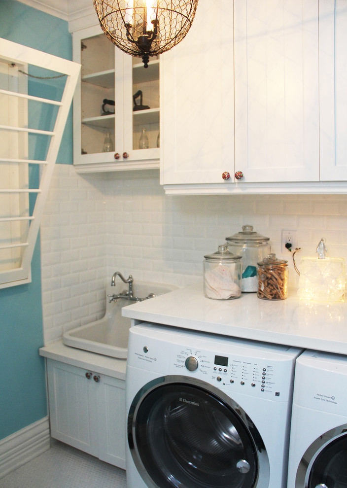 This is an example of a medium sized classic galley separated utility room in Toronto with a single-bowl sink, shaker cabinets, laminate countertops, blue walls, lino flooring and a side by side washer and dryer.