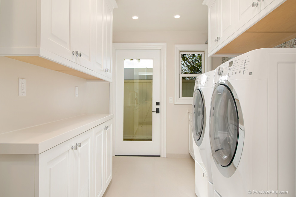 Photo of a medium sized nautical galley separated utility room in Orange County with raised-panel cabinets, white cabinets, engineered stone countertops, beige walls, porcelain flooring and a side by side washer and dryer.