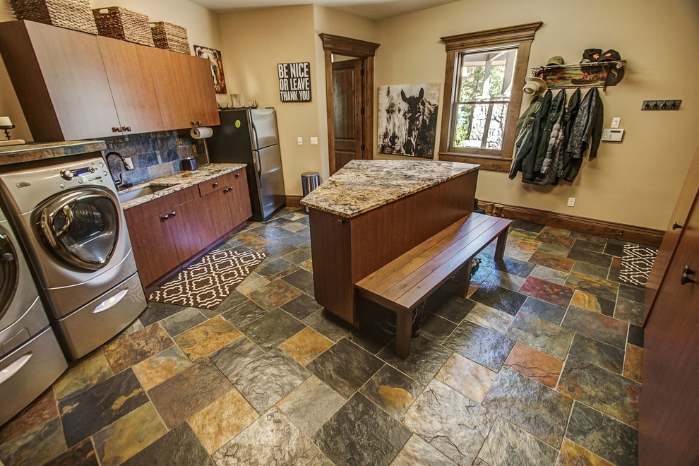 Large mountain style galley slate floor and multicolored floor utility room photo in Boise with an undermount sink, flat-panel cabinets, granite countertops, beige walls, a side-by-side washer/dryer, brown countertops and dark wood cabinets