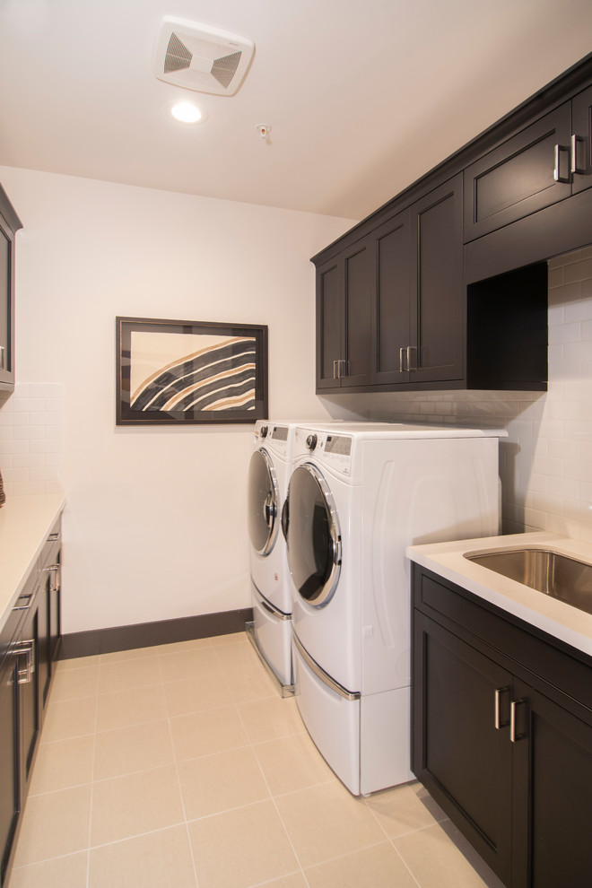 Photo of a traditional galley utility room in San Francisco with recessed-panel cabinets and black cabinets.