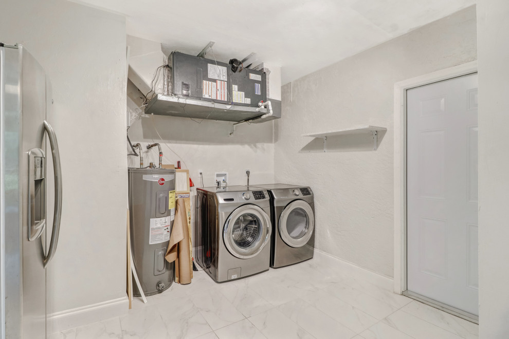 Example of a country laundry room design in Other with a side-by-side washer/dryer