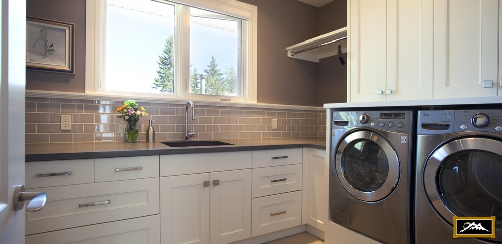 Example of a transitional laundry room design in Calgary