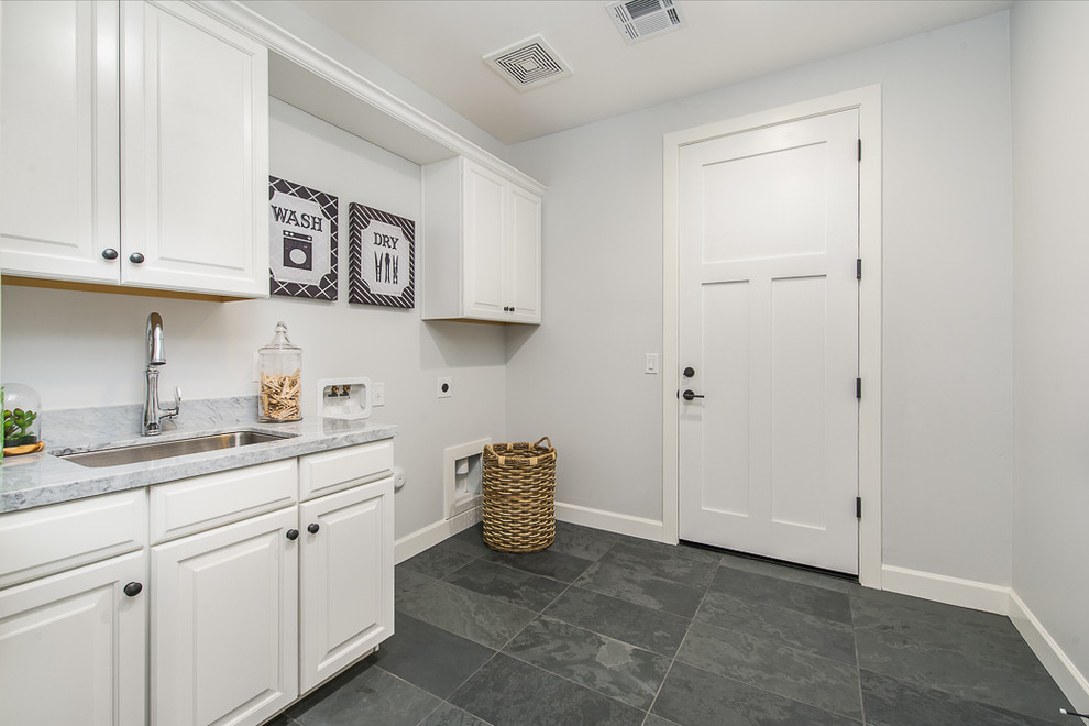 Inspiration for a medium sized traditional single-wall separated utility room in Phoenix with raised-panel cabinets, white cabinets, marble worktops, grey walls, ceramic flooring, a side by side washer and dryer and a submerged sink.