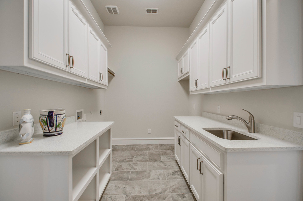 Utility room - large traditional galley utility room idea in Dallas with an undermount sink and granite countertops