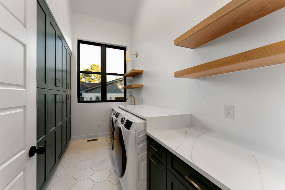 Photo of a modern utility room in Denver with a submerged sink, shaker cabinets, green cabinets, quartz worktops, white walls, porcelain flooring, a side by side washer and dryer, white floors and white worktops.