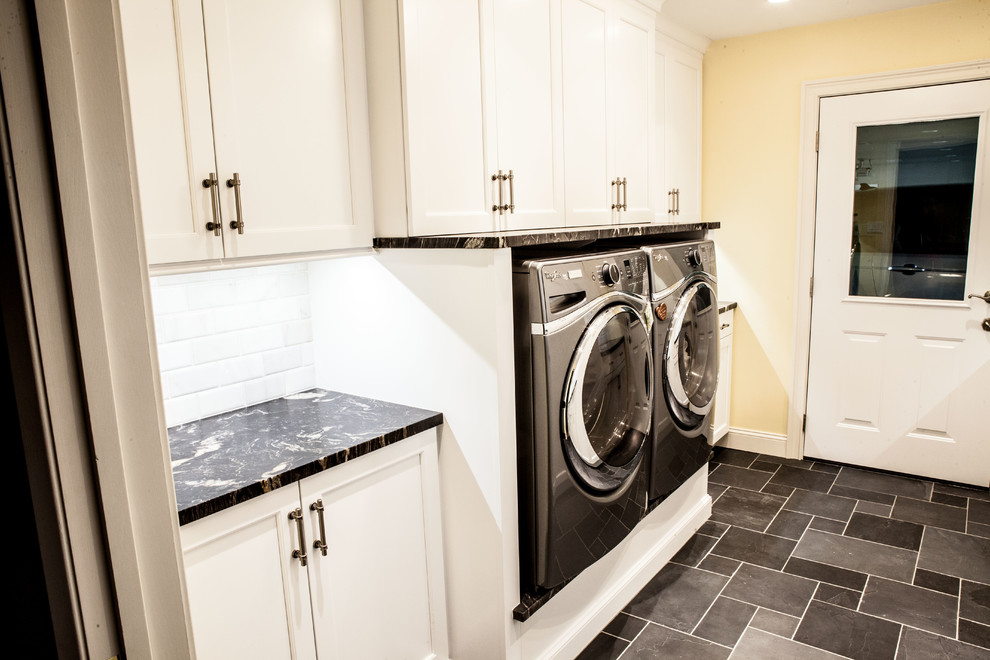 Inspiration for a medium sized classic galley separated utility room in Wichita with a submerged sink, recessed-panel cabinets, white cabinets, marble worktops, yellow walls, slate flooring, a side by side washer and dryer and grey floors.