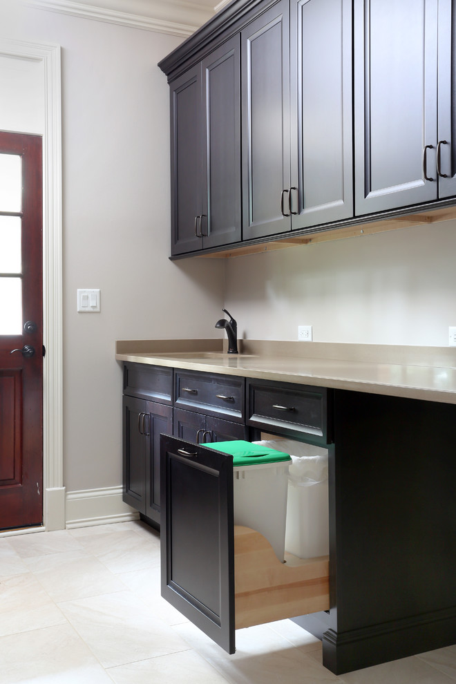 Example of a mid-sized transitional galley porcelain tile utility room design in Chicago with recessed-panel cabinets, dark wood cabinets and quartz countertops