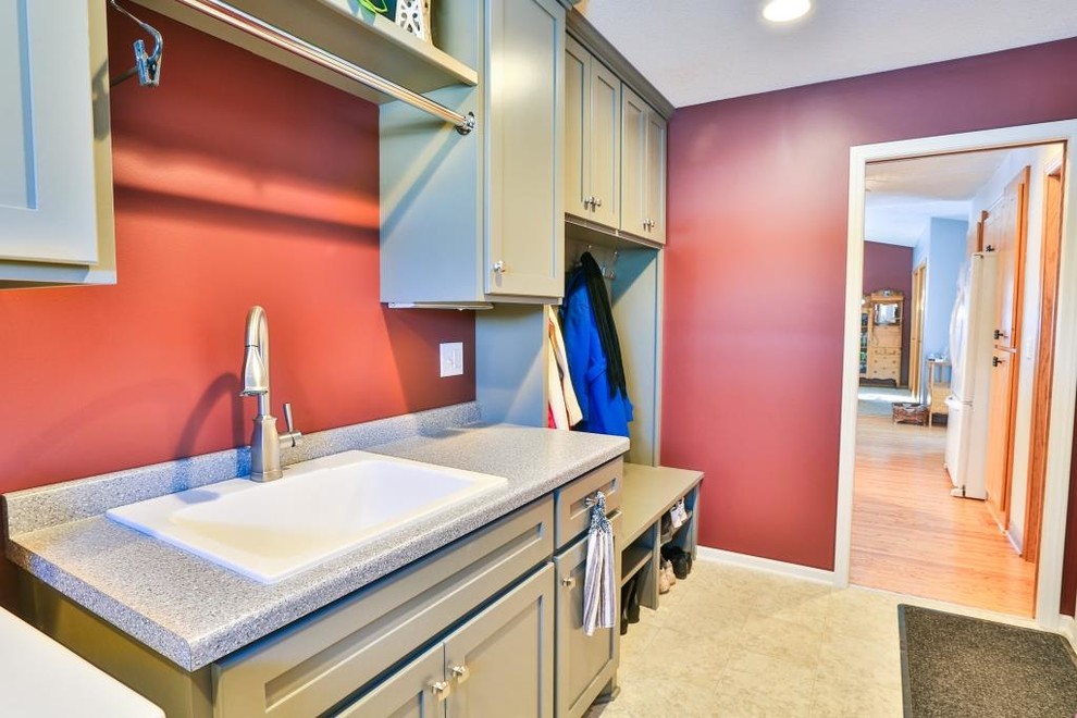 Inspiration for a mid-sized transitional galley ceramic tile utility room remodel in Minneapolis with a drop-in sink, shaker cabinets, beige cabinets, granite countertops, red walls and a side-by-side washer/dryer
