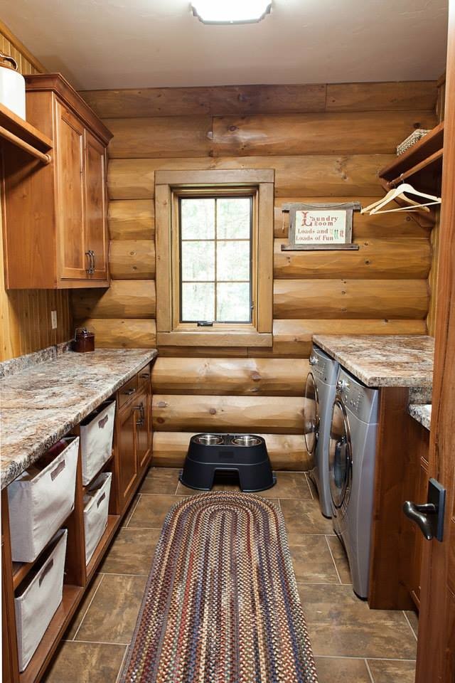 Inspiration for a mid-sized rustic galley ceramic tile dedicated laundry room remodel in Other with a drop-in sink, flat-panel cabinets, medium tone wood cabinets, marble countertops, brown walls and a side-by-side washer/dryer