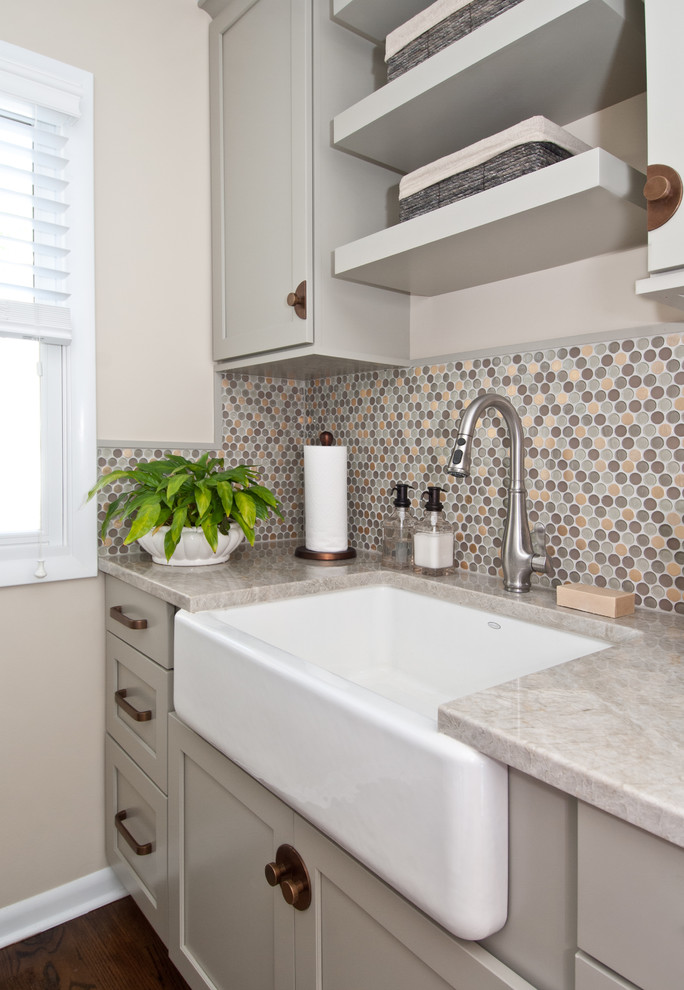 This is an example of a classic utility room in Chicago with a belfast sink, shaker cabinets, grey cabinets, beige walls, dark hardwood flooring, brown floors and beige worktops.