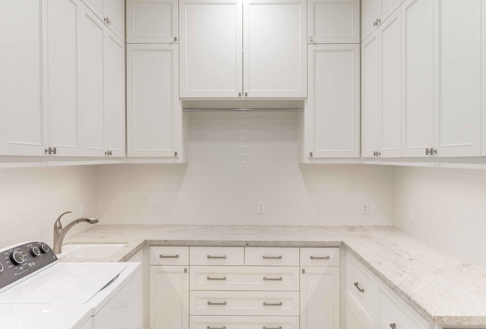 Medium sized classic u-shaped utility room in Houston with a submerged sink, recessed-panel cabinets, white cabinets, granite worktops, white walls, ceramic flooring and a side by side washer and dryer.