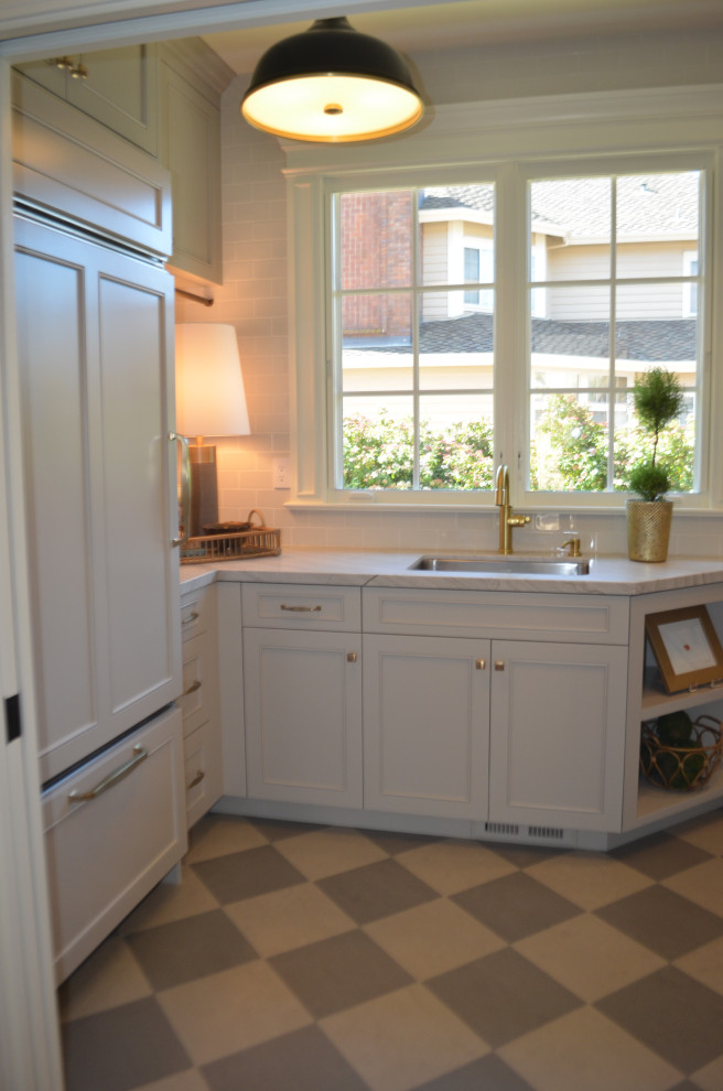 Small transitional u-shaped porcelain tile and gray floor utility room photo in San Francisco with an undermount sink, gray cabinets, quartzite countertops, gray walls, a stacked washer/dryer and gray countertops