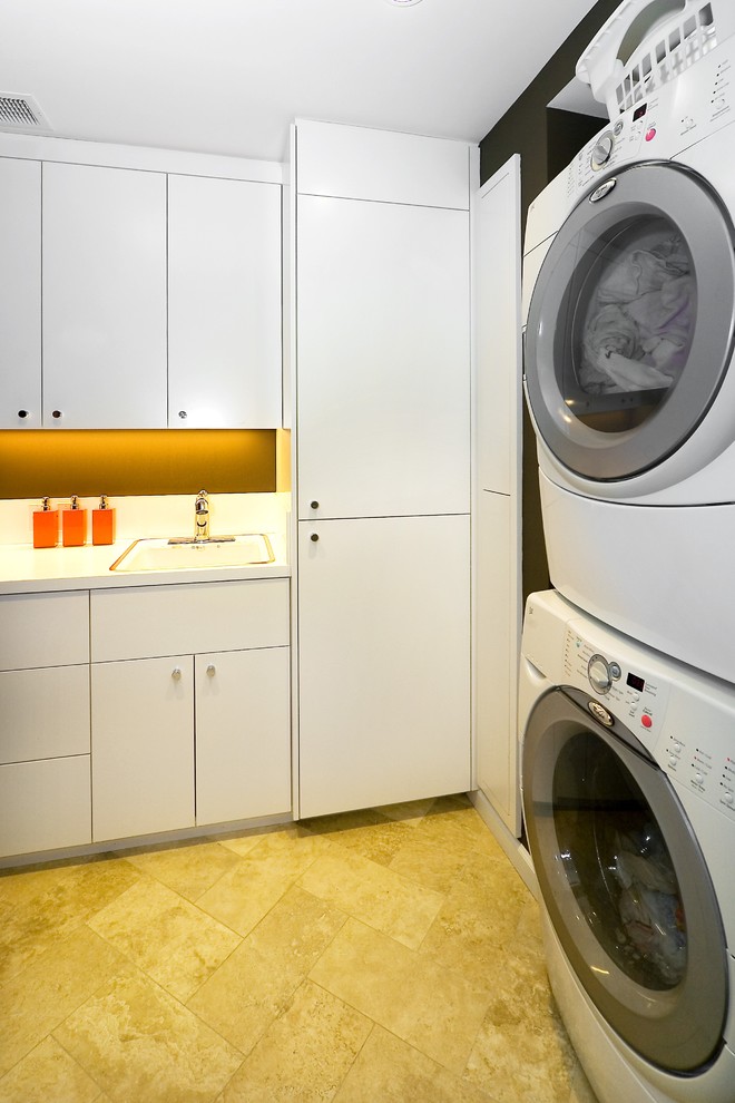 Idéer för att renovera en funkis tvättstuga, med en tvättpelare, vita skåp och gult golv
