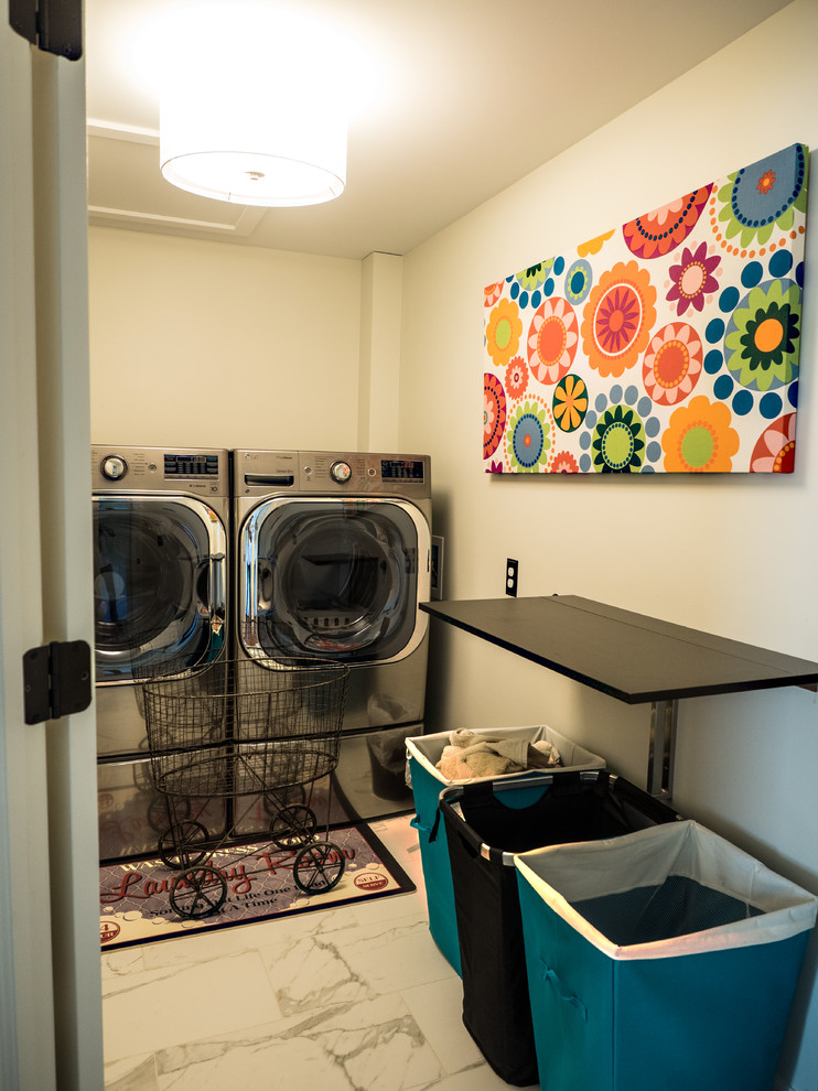 Inspiration for an eclectic u-shaped ceramic tile dedicated laundry room remodel in Detroit with recessed-panel cabinets, light wood cabinets, laminate countertops, beige walls and a side-by-side washer/dryer