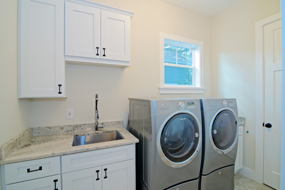 Photo of a medium sized traditional single-wall separated utility room in Jacksonville with a submerged sink, shaker cabinets, white cabinets, granite worktops, white walls, ceramic flooring and a side by side washer and dryer.