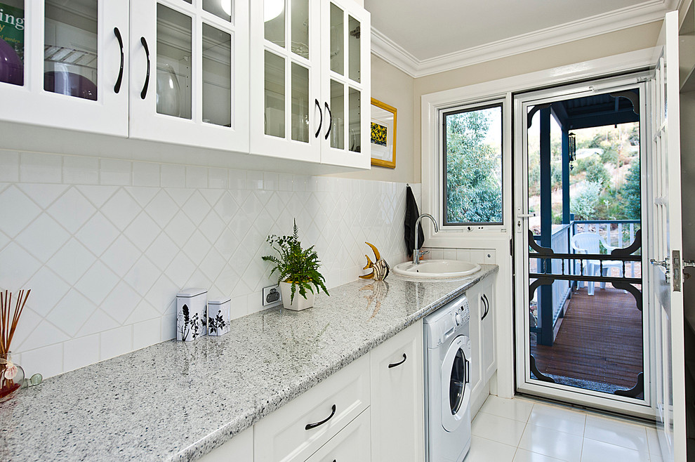 Example of a classic galley ceramic tile dedicated laundry room design in Perth with a drop-in sink, recessed-panel cabinets, white cabinets and laminate countertops