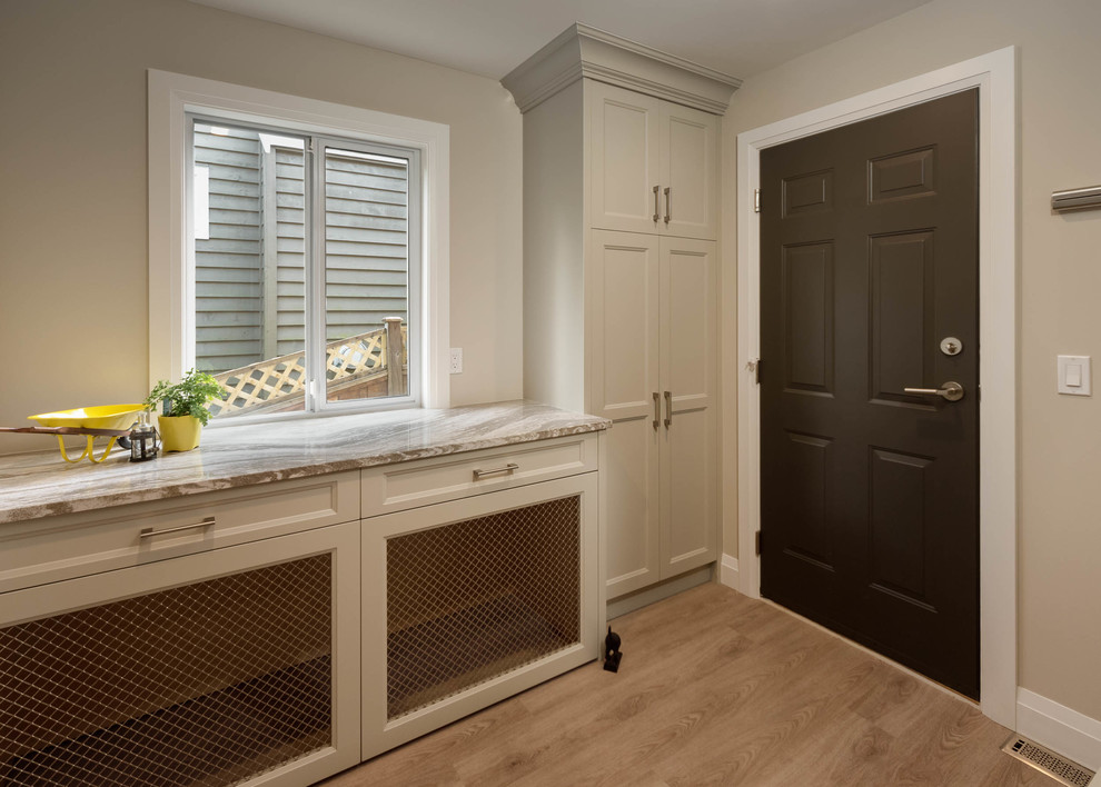 Inspiration for a large contemporary single-wall separated utility room in Vancouver with shaker cabinets, beige cabinets, quartz worktops, beige walls, medium hardwood flooring and brown floors.