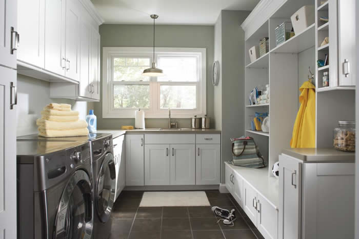 Medium sized traditional u-shaped utility room in Other with a submerged sink, shaker cabinets, white cabinets, ceramic flooring and a side by side washer and dryer.