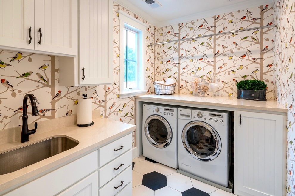 Foto på en vintage tvättstuga, med en undermonterad diskho, luckor med profilerade fronter, vita skåp, bänkskiva i kvarts, klinkergolv i porslin och en tvättmaskin och torktumlare bredvid varandra