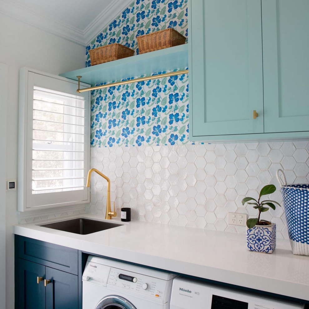 This is an example of a beach style utility room in Other.
