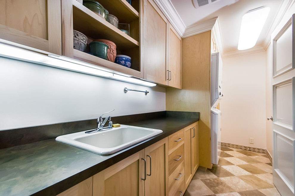 Example of a classic laundry room design in San Francisco with a stacked washer/dryer
