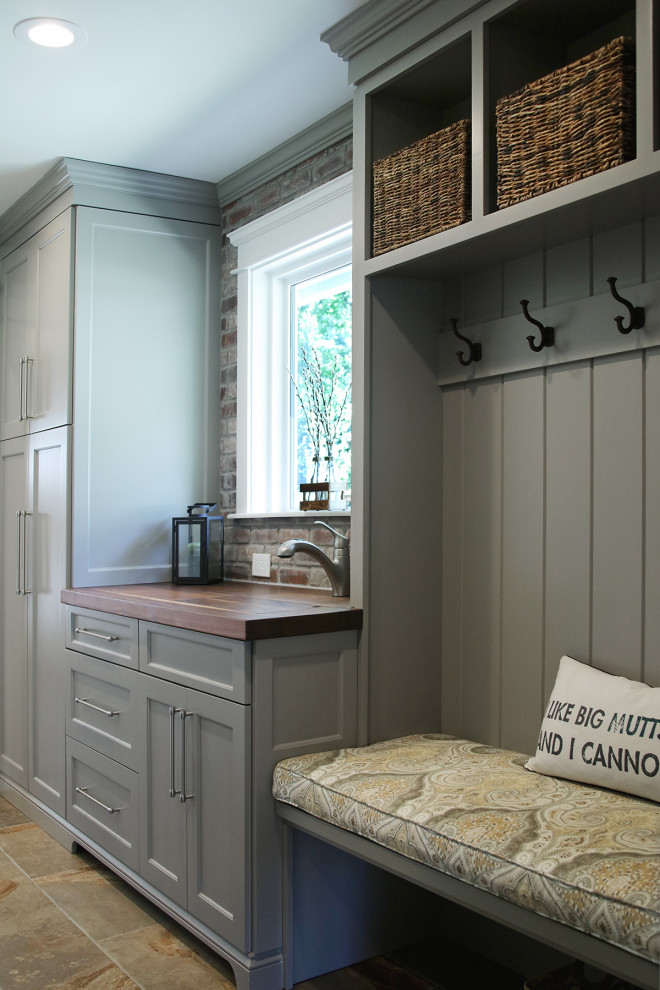 Inspiration for a medium sized traditional galley utility room in Atlanta with an utility sink, recessed-panel cabinets, grey cabinets, wood worktops, grey walls, porcelain flooring, a side by side washer and dryer, brown floors and multicoloured worktops.