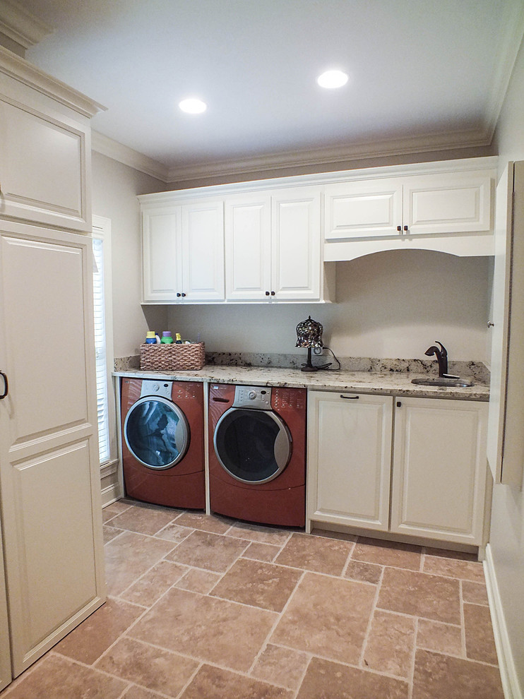 Large elegant single-wall ceramic tile and beige floor dedicated laundry room photo in Cleveland with a single-bowl sink, raised-panel cabinets, white cabinets, granite countertops, white walls and a side-by-side washer/dryer