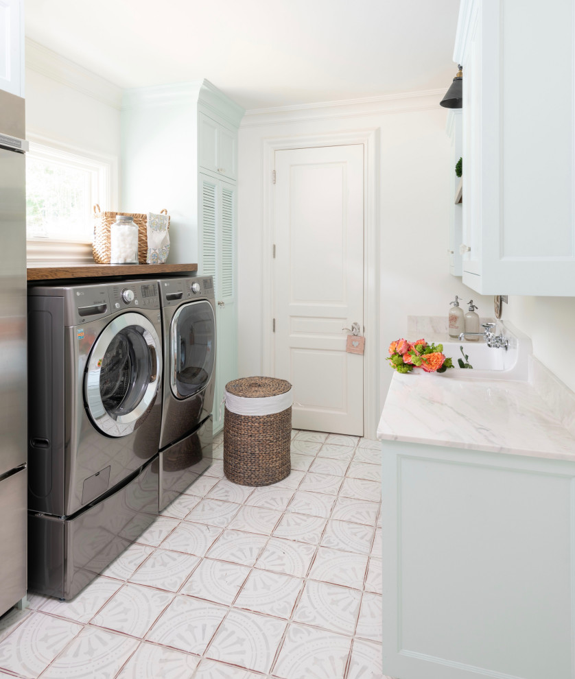 Medium sized classic l-shaped utility room in Austin with an utility sink, raised-panel cabinets, blue cabinets, quartz worktops, white walls, terracotta flooring, a side by side washer and dryer, multi-coloured floors and beige worktops.
