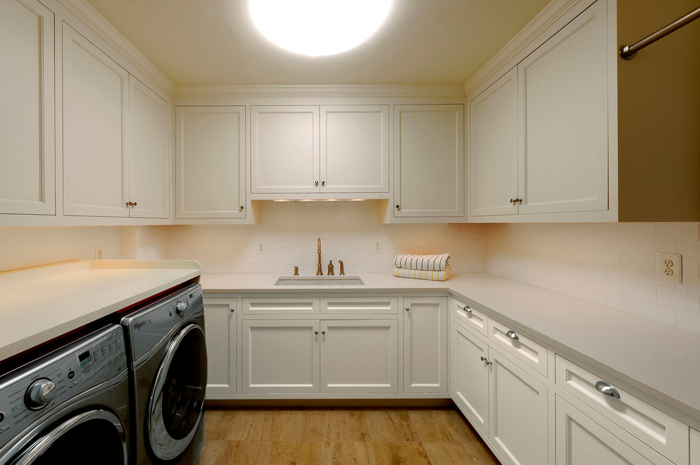 Contemporary separated utility room in DC Metro with a belfast sink, white walls and a side by side washer and dryer.