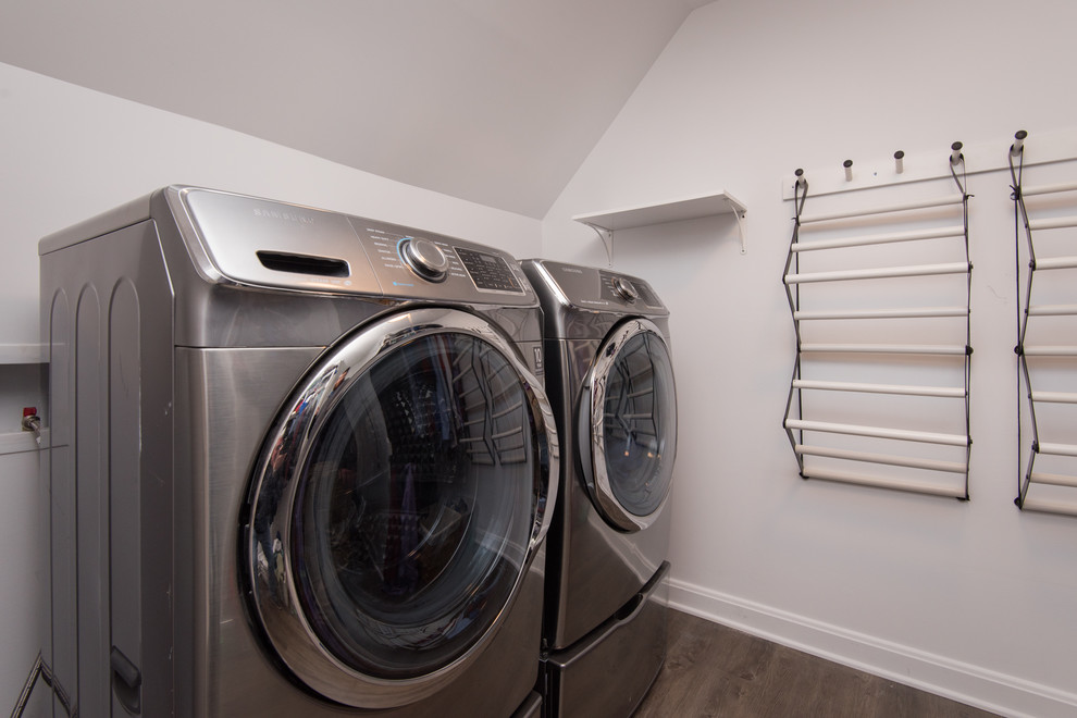 Medium sized classic single-wall separated utility room in Louisville with white walls, dark hardwood flooring, a side by side washer and dryer and brown floors.