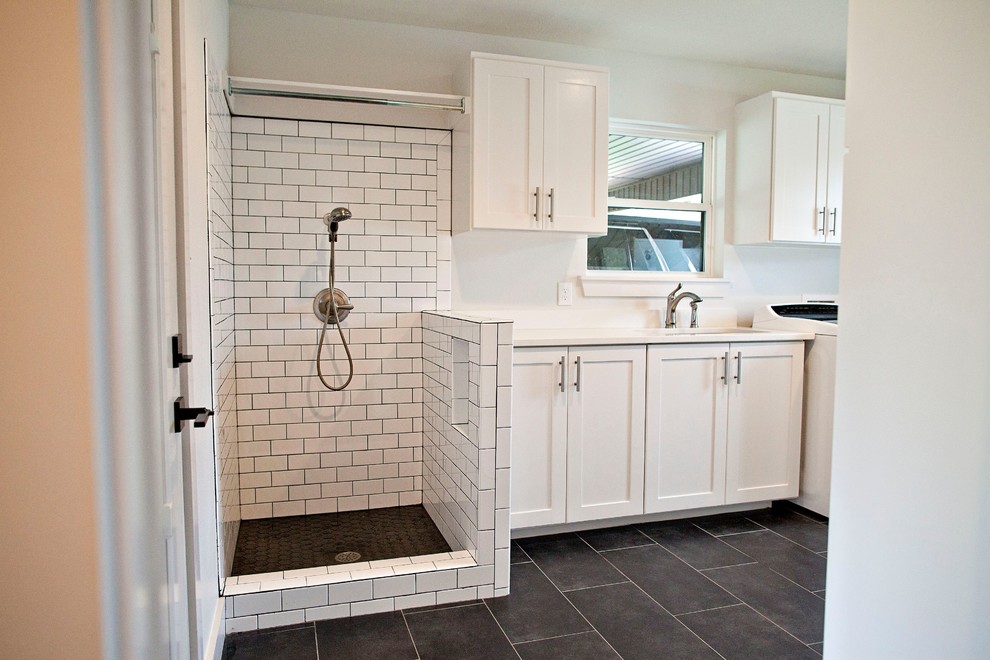 Cottage ceramic tile and black floor laundry room photo in Dallas with an undermount sink, shaker cabinets, white cabinets, quartzite countertops, white walls, a side-by-side washer/dryer and white countertops
